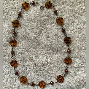 Bronze/brown necklace.